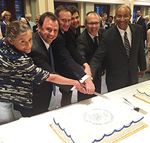 All current Commissioners cutting the USITC Centennial cake at the  reception. Shown from left to right are Commissioners Broadbent and  Kieff, Vice Chairman Johanson, Commissioners Schmidtlein and Pinkert, and Chairman Williamson. 